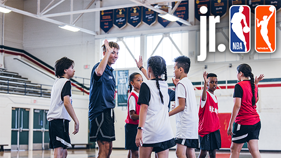 Group of children with coach on a basketball court